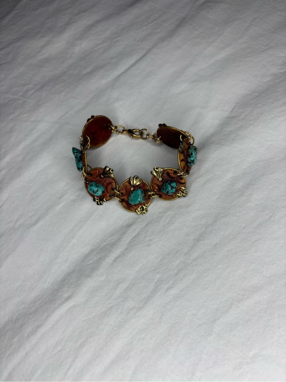 Vintage turquoise bracelet with turquoise stones set in ornate metalwork